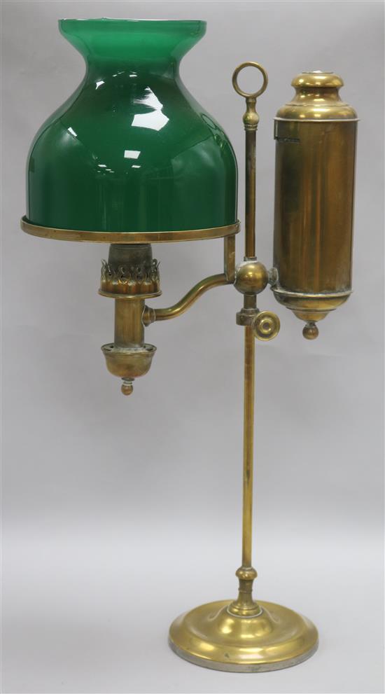 A brass students lamp with green glass shade